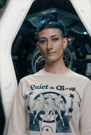 Abigail standing in a passage way on an AI generated spacecraft interior.